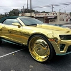 Gold Soaked King zl1 Camaro Rides on 30 inch Gilded Wheels with three 23 Inch TvsK